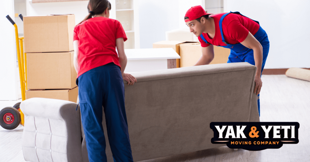 a man and woman arranging the couch.
