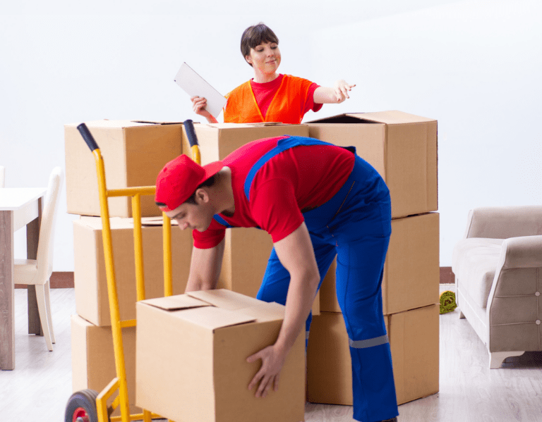a man and woman moving boxes