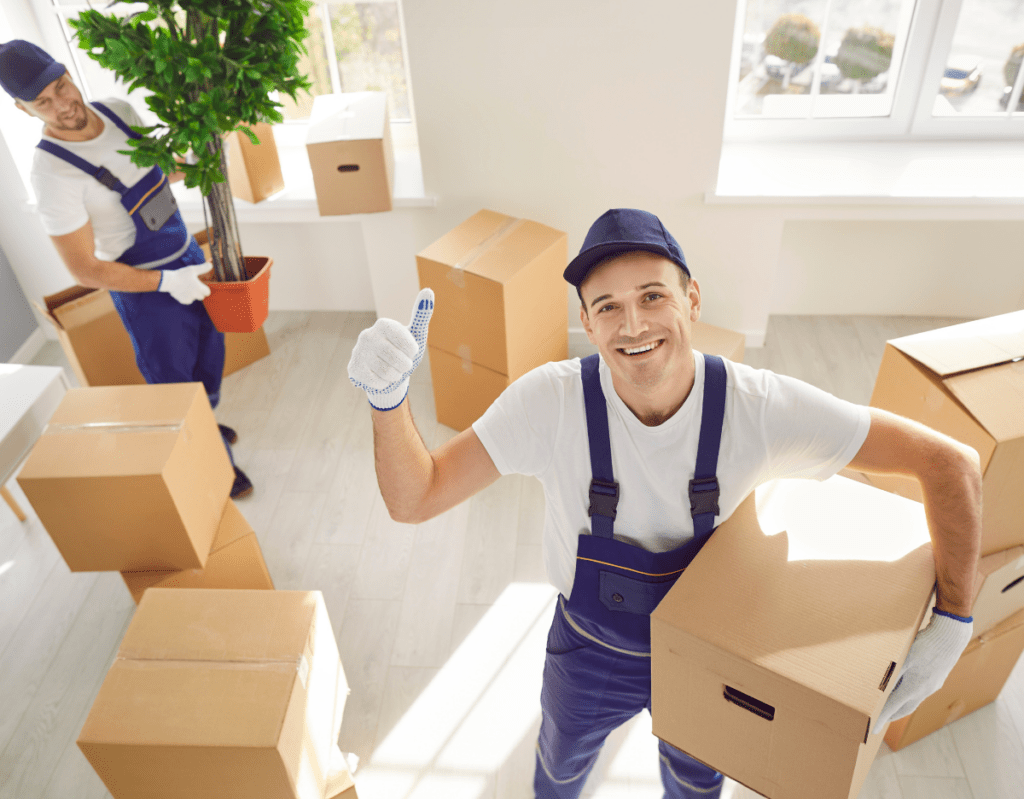 a man in overalls holding boxes