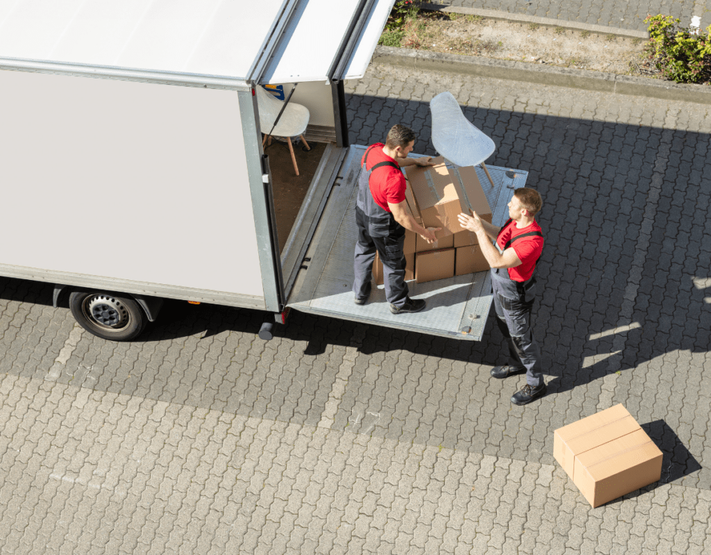 men standing on the back of a truck loading boxes
