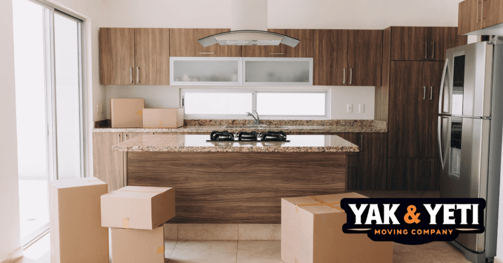 a kitchen with boxes in the background